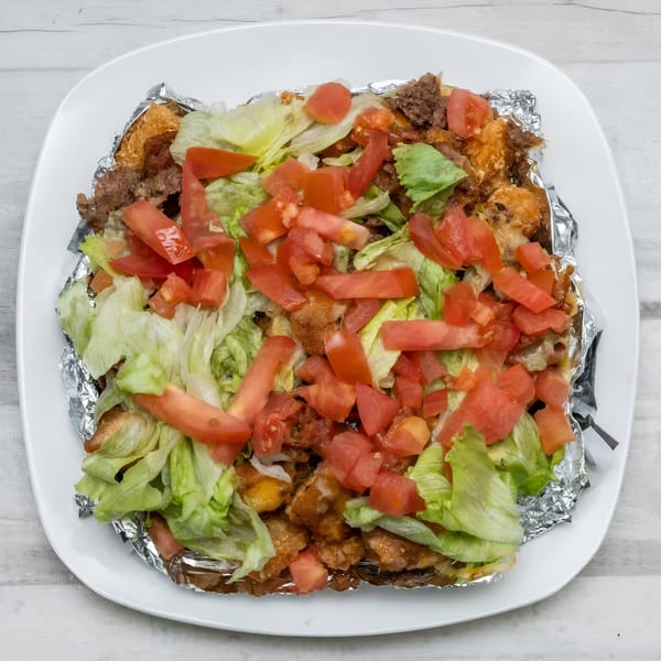 Rock Burger's loaded fries with ground beef, melted cheese, diced tomatoes, and shredded lettuce.